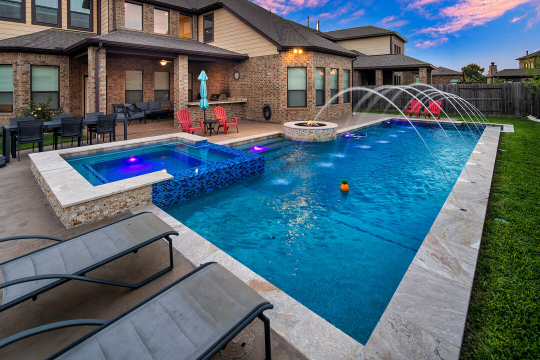 Geometric Pool with Deck Jets and Outdoor Kitchen in Cypress, Texas